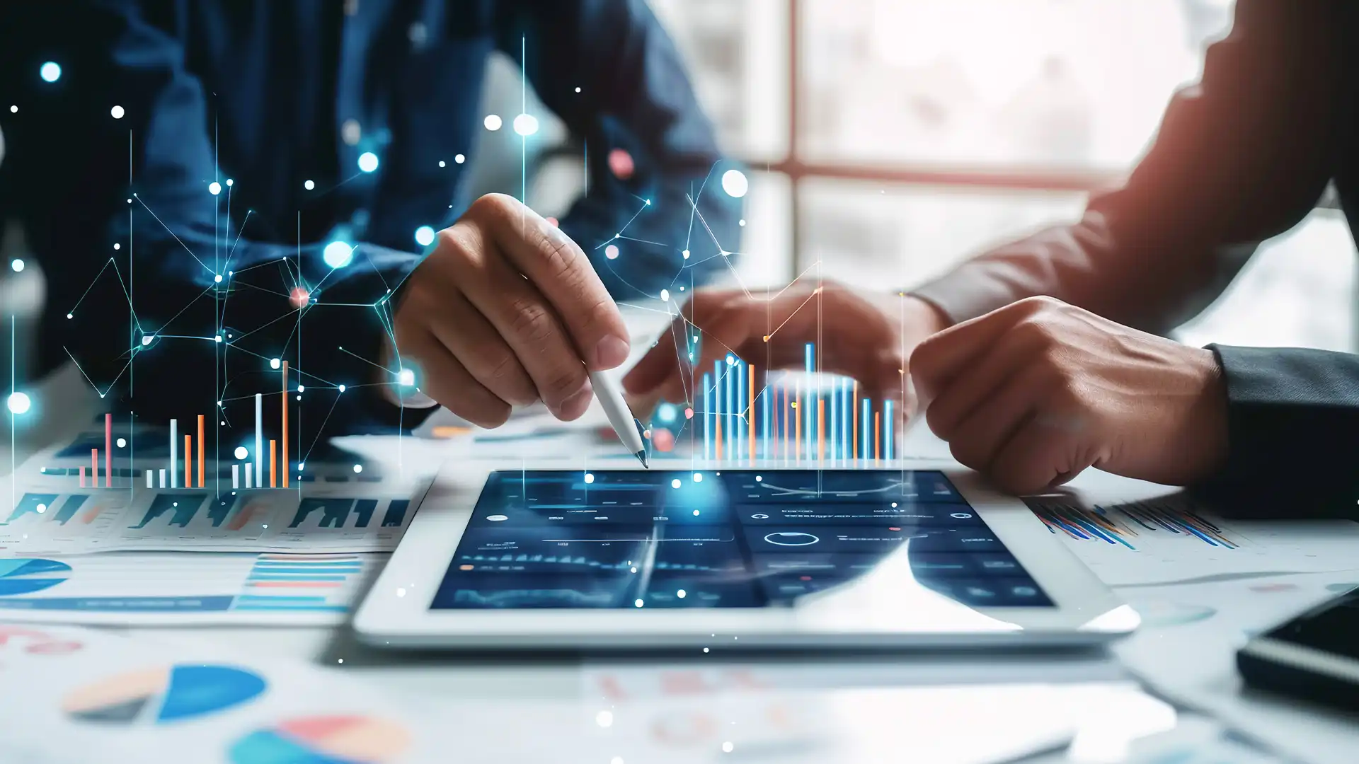 Two business professionals collaboratively analyzing strategic data on a tablet, exemplifying Prudent's 'Assess & Architect' approach to identify inefficiencies and tailor technology investments for cost-effectiveness and strategic business alignment